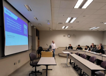 Image of speaker and presentation.